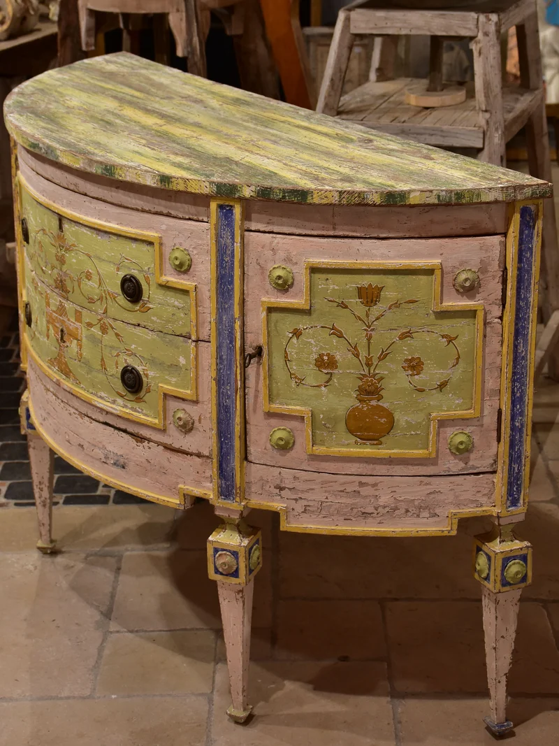 Demilune commode with pink, green, yellow and blue patina
